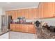 A kitchen showcases stainless steel appliances, wood cabinets, and granite countertops at 1779 E Kaibab Dr, Chandler, AZ 85249
