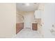 Laundry room with storage, sink, tiled floors, and a utility closet at 1779 E Kaibab Dr, Chandler, AZ 85249