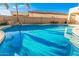 Refreshing backyard pool with a rock feature and sparkling blue water, ideal for summer fun at 1779 E Kaibab Dr, Chandler, AZ 85249