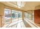 Bright sun room with tile floors and windows overlooking the backyard pool and landscaping at 1779 E Kaibab Dr, Chandler, AZ 85249