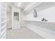 Spacious walk-in closet featuring ample shelving, carpeted floors, and a natural light filled window at 1779 E Kaibab Dr, Chandler, AZ 85249