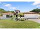 Charming single-story home with a red tile roof, lush lawn, and a well-manicured desert landscape at 3117 E Maryland Ave, Phoenix, AZ 85016