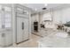 Bright kitchen featuring a modern range hood, stainless steel appliances, and marble countertops at 3117 E Maryland Ave, Phoenix, AZ 85016