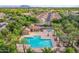 Community amenities include a pool, barbeque and lounge area surrounded by lush palm trees and well-maintained landscaping at 4615 E Calistoga Dr, Gilbert, AZ 85297