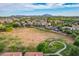 Scenic aerial view of a lush neighborhood with green spaces and mountain views at 4615 E Calistoga Dr, Gilbert, AZ 85297