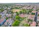 Aerial view showcasing a neighborhood with green spaces, pool, and recreational areas at 4615 E Calistoga Dr, Gilbert, AZ 85297