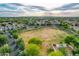 Scenic aerial view of a neighborhood featuring grassy area, lush greenery, and mountain backdrop at 4615 E Calistoga Dr, Gilbert, AZ 85297