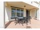 Covered patio with brick flooring and wrought iron furniture seating at 4615 E Calistoga Dr, Gilbert, AZ 85297