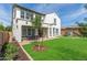 Spacious backyard with lush lawn, mature landscaping, patio, and playground at 4615 E Calistoga Dr, Gilbert, AZ 85297