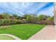 Lush backyard featuring mature trees, manicured landscaping, and brick-paved pathways at 4615 E Calistoga Dr, Gilbert, AZ 85297