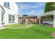 Spacious backyard with artificial grass, playground, and hot tub with pergola at 4615 E Calistoga Dr, Gilbert, AZ 85297