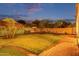 A large yard with brick pavers, green grass, trees, and a privacy wall at 4615 E Calistoga Dr, Gilbert, AZ 85297