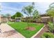 Manicured backyard with green grass, mature trees, and a gazebo with a hot tub, ideal for relaxation at 4615 E Calistoga Dr, Gilbert, AZ 85297