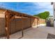 Backyard showcasing a pergola-covered area with a concrete pad and block wall at 4615 E Calistoga Dr, Gilbert, AZ 85297