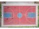 Overhead shot of a community basketball court featuring red and blue zones, surrounded by sidewalks and landscaping at 4615 E Calistoga Dr, Gilbert, AZ 85297