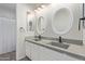 Elegant bathroom featuring double sinks with modern fixtures, complemented by stylish oval mirrors at 4615 E Calistoga Dr, Gilbert, AZ 85297
