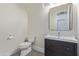 Half bathroom featuring modern fixtures, a dark wood vanity, and a sleek mirror at 4615 E Calistoga Dr, Gilbert, AZ 85297