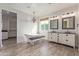 Bright bathroom featuring a soaking tub, dual vanity, wood-look floors and a window with natural light at 4615 E Calistoga Dr, Gilbert, AZ 85297