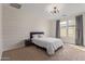 Serene bedroom with shiplap accent wall, carpet flooring, and a bright window, offering a tranquil retreat at 4615 E Calistoga Dr, Gilbert, AZ 85297