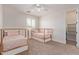 Bedroom featuring 2 beds, window and fan with a closet near doorway at 4615 E Calistoga Dr, Gilbert, AZ 85297