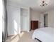 Bright bedroom featuring sliding closet doors, neutral carpet, and modern ceiling light fixture at 4615 E Calistoga Dr, Gilbert, AZ 85297