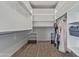 Spacious walk-in closet with built-in shelving and hanging rods for optimal storage and organization at 4615 E Calistoga Dr, Gilbert, AZ 85297