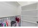 Spacious walk-in closet with built-in shelves and racks to provide ample storage for clothing and accessories at 4615 E Calistoga Dr, Gilbert, AZ 85297
