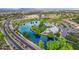 Aerial of a large pond, club house, pool, with homes and parks in the surrounding area at 4615 E Calistoga Dr, Gilbert, AZ 85297