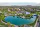 An aerial shot of a stunning resort style pool with a splash pad and shade umbrellas surrounded by lush landscaping at 4615 E Calistoga Dr, Gilbert, AZ 85297