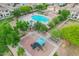 Aerial view of the community pool and playground surrounded by landscaping, homes and plenty of green space at 4615 E Calistoga Dr, Gilbert, AZ 85297