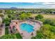 Overhead view of a community pool and hot tub with a splash pad, surrounded by lush greenery at 4615 E Calistoga Dr, Gilbert, AZ 85297