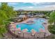 Aerial shot of a neighborhood pool featuring shade umbrellas, seating, a splash pad, and bathroom facilities at 4615 E Calistoga Dr, Gilbert, AZ 85297