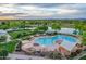 Aerial view of a resort style pool surrounded by lounge seating, shade umbrellas, landscaping and open space at 4615 E Calistoga Dr, Gilbert, AZ 85297