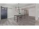 Bright dining area with wood floors, slider door, and modern light fixture at 4615 E Calistoga Dr, Gilbert, AZ 85297