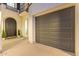 Inviting entry featuring a dark door and a gray garage door with matching plants at 4615 E Calistoga Dr, Gilbert, AZ 85297