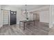 Bright entryway with wood floors, slider door, and modern light fixture at 4615 E Calistoga Dr, Gilbert, AZ 85297