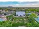 Bird's-eye view of the event venue, adjacent to a pond, grass area, trees and parking at 4615 E Calistoga Dr, Gilbert, AZ 85297