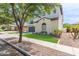Front exterior view of the house, featuring manicured lawn and stucco exterior at 4615 E Calistoga Dr, Gilbert, AZ 85297