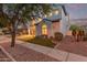 Elegant two-story house featuring a tile roof, a balcony, and a well-maintained lawn, surrounded by mature trees at 4615 E Calistoga Dr, Gilbert, AZ 85297