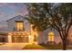 Charming two-story home with a two-car garage and a balcony, complemented by well-manicured landscaping and mature trees at 4615 E Calistoga Dr, Gilbert, AZ 85297
