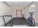 A well-equipped home gym in the garage with Rogue squat rack and exercise bike at 4615 E Calistoga Dr, Gilbert, AZ 85297