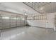 A clean garage with epoxy floors, storage racks, and modern garage door at 4615 E Calistoga Dr, Gilbert, AZ 85297