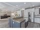 Spacious kitchen featuring a center island, white cabinetry, stainless steel refrigerator, and an open layout at 4615 E Calistoga Dr, Gilbert, AZ 85297