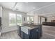 Bright kitchen boasts a central island with a farmhouse sink, stainless steel appliances, and wood-look flooring at 4615 E Calistoga Dr, Gilbert, AZ 85297
