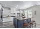 Well-designed kitchen showcases a center island with seating, white cabinets, and stainless steel appliances at 4615 E Calistoga Dr, Gilbert, AZ 85297