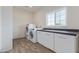 Convenient laundry room with appliances and a countertop area with white cabinets for storage at 4615 E Calistoga Dr, Gilbert, AZ 85297