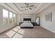 Serene main bedroom with a tray ceiling, large windows, and a four-poster bed at 4615 E Calistoga Dr, Gilbert, AZ 85297