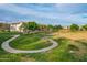 Lush neighborhood park with a pathway and seating, offering a relaxing outdoor space for residents of the community at 4615 E Calistoga Dr, Gilbert, AZ 85297