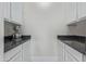 Walk-in pantry offering generous cabinet space with dark countertops and ample storage, ideal for kitchen organization at 4615 E Calistoga Dr, Gilbert, AZ 85297