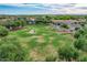Aerial view of a lush community park with a walking path, gazebo, and mature trees, providing a serene escape for residents at 4615 E Calistoga Dr, Gilbert, AZ 85297